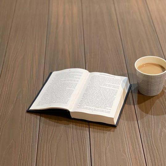 Oak Composite Decking With A Book And Cup Of Coffee - Assured Composite