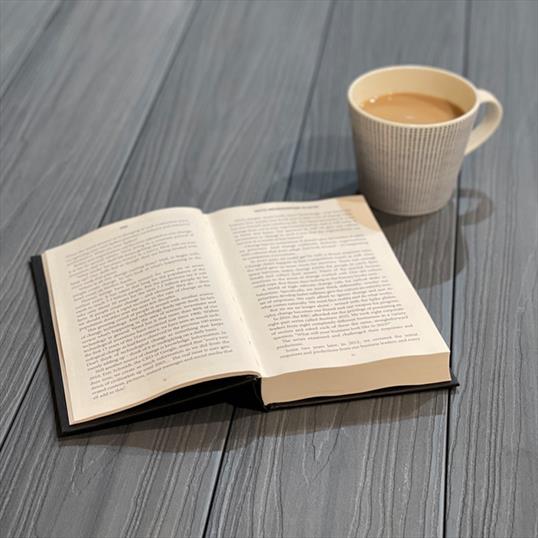 Stone Grey Composite Decking With Book And Cup Of Coffee - Assured Composite