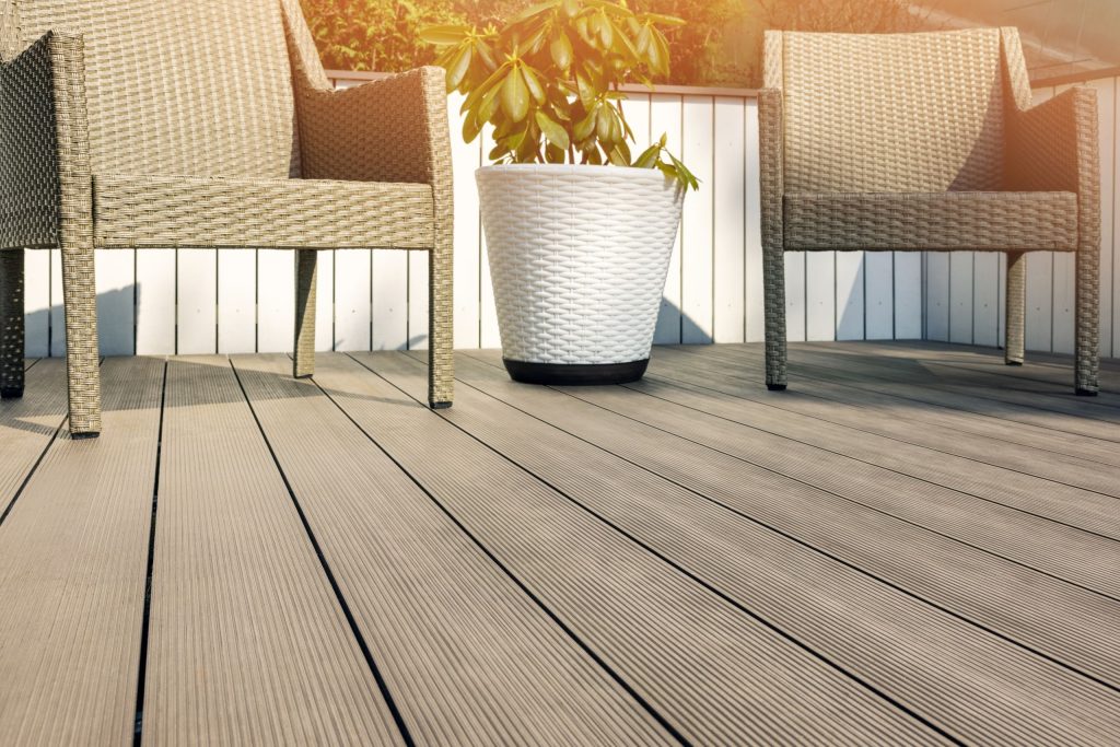 Grey rattan outdoor garden furniture sitting on a composite deck