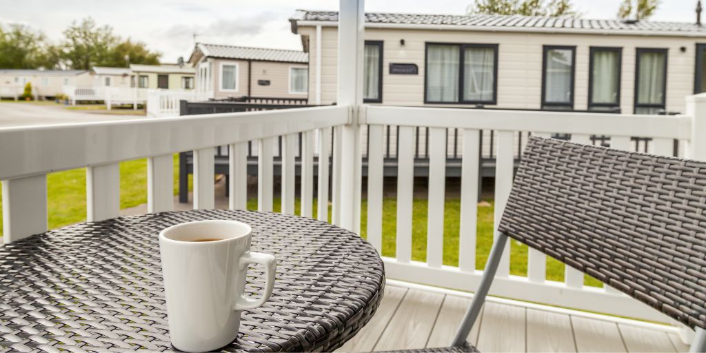 Static caravan decking with bistro table and a cup of tea